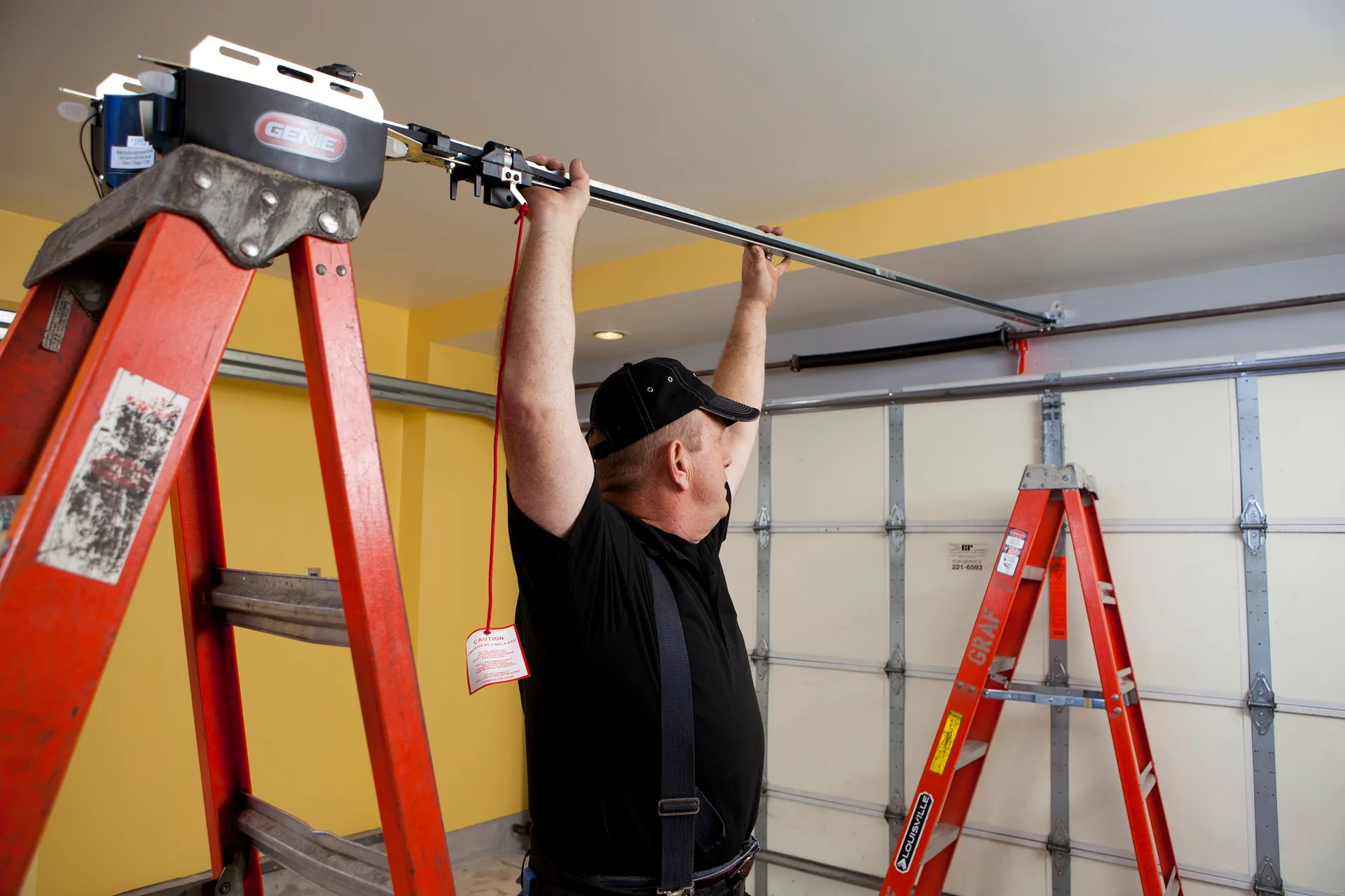 Technician installing a garage door opener